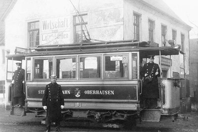 Three men in an old STOAG tram